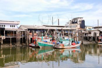 living boats on chao phraya river in bangkok, thailand