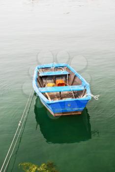 blue boat in water on Bay of Biscay in cambados town, galicia, spain