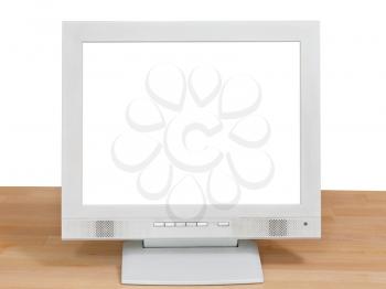 front view of grey computer display with cut out screen on wooden table isolated on white background