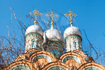 gold crosses on domes of russian church (Church of St. Gregory of Neocaesarea in Derbitsah, Moscow)