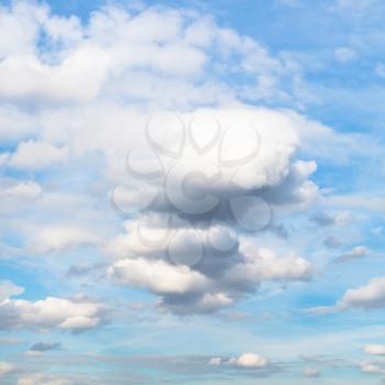 white and grey cumulus clouds in blue autumn sky - natural background