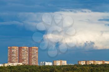 dark blue rainy clouds over multistory houses in summer evening, Moscow