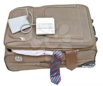 sphygmomanometer on suitcase with male ties isolated on white background
