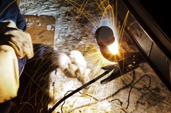 welding car turnbuckle in snow field at night close up