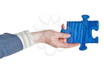 male hand with painted blue puzzle piece isolated on white background