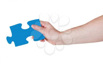 male hand with blue puzzle piece isolated on white background