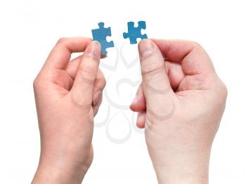 pair of male and female hands with little puzzle pieces isolated on white background