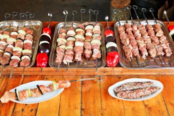 Crimean tatar cuisine - skewers of raw lamb shish kebabs and vegetables