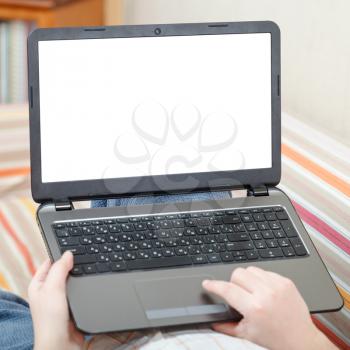 man uses laptop with cut out screen in living room