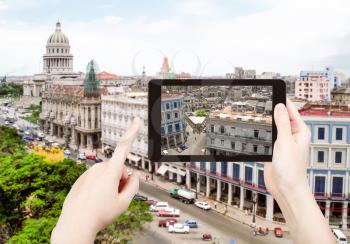 travel concept - tourist taking photo of center Havana city on mobile gadget, Cuba