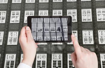travel concept - tourist taking photo of exterior office building on mobile gadget, Hamburg, Germany