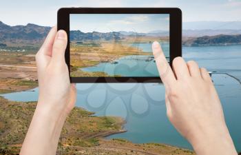 travel concept - tourist taking photo of Lake Mead in Nevada on mobile gadget, Nevada, USA
