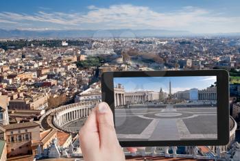 travel concept - tourist taking photo of St.Peter Square with Egyptian obelisk in Rome, Italy on mobile gadget