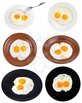 set from two fried eggs on plates isolated on white background