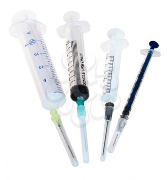 four new empty medical plastic disposable syringes isolated on white background