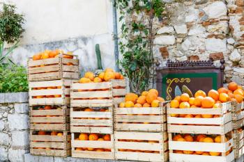 fresh crop of oranges in wooden boxes on a street market in Taormina town, Sicily, Italy in spring