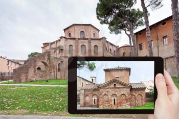 travel concept - tourist takes picture of Basilica of San Vitale - ancient church and Galla Placidia mausoleum in Ravenna, Italy on tablet pc