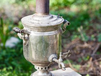 old steel samovar - boiling kettle on backyard