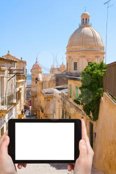 travel concept - tourist photograph street stairway in Noto - baroque style town in Sicily, Italy on tablet pc with cut out screen with blank place for advertising logo