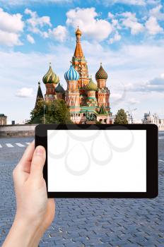 travel concept - tourist photograph Pokrovsky cathedral on Red square in Moscow, Russia on tablet pc with cut out screen with blank place for advertising logo