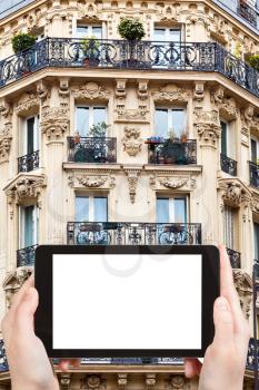 travel concept - tourist photograph corner of of typical house with balcony in Saint-germain-des-pres , Paris, France on tablet pc with cut out screen with blank place for advertising logo
