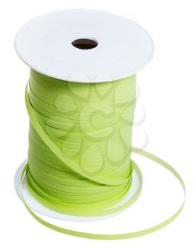 white plastic bobbin with green packing tape isolated on white background