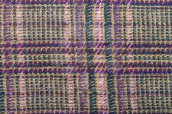background from checkered green, brown, violet, pink woolen fabric close up