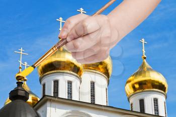 travel concept - hand paints by painbrush golden cupola on russian church