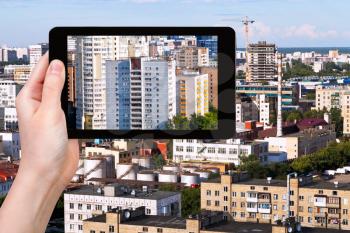travel concept - tourist photographs picture of city on tablet pc
