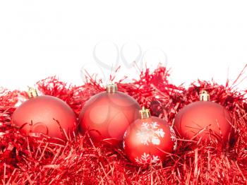 few red Xtmas baubles and tinsel isolated on white background
