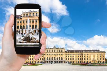 travel concept - tourist snapshot of fountain near Schloss Schonbrunn palace in Vienna on smartphone