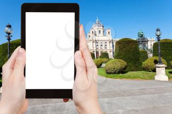 travel concept - tourist photographs Museum Natural History (Naturhistorisches) at Maria Theresien Platz in Vienna on tablet pc with cut out screen with blank place for advertising logo