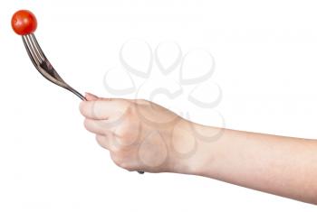 hand holds fork with impaled one fresh red cherry tomato isolated on white background