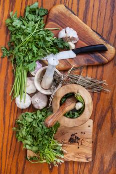 cooking seasonings - top view of mortars and fresh herbs on wooden table