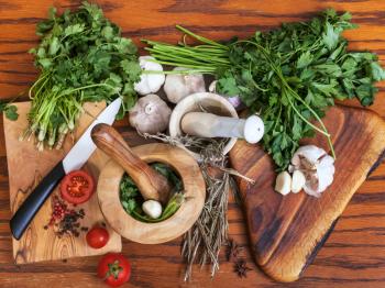 cooking seasonings - above view of mortars and spicy ingredients on wooden table