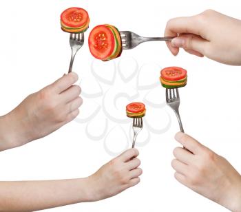 set of dinning forks with impaled fresh sliced vegetables isolated on white background