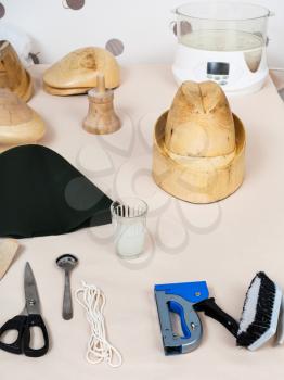 workshop for alpine felt hat making - tools and equipment for hatmaking on table