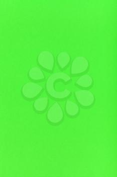 vertical background from bright green colored sheet of paper