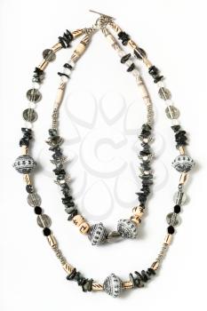necklace from coquina, beads, acrylic, rhinestone, bone, metal beads on white background