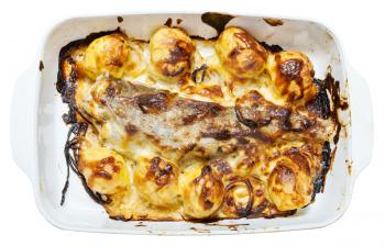 pollack fish baked with potatoes, onions, mayonnaise, cheese in ceramic pan in oven