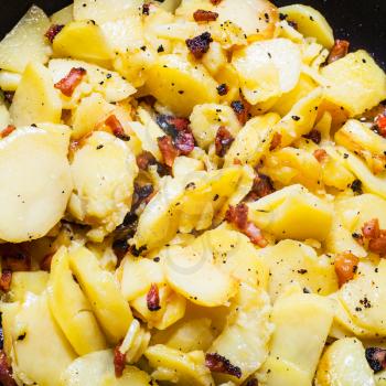 food background - fried potatoes with pork cracklings close up