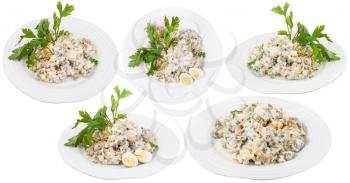 set of plates with olivier russian salad with mayonnaise isolated on white background