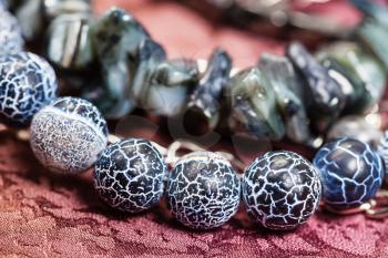 detail of gray blue necklace from natural gemstones - Dragon Veins Agate and shells beads close up