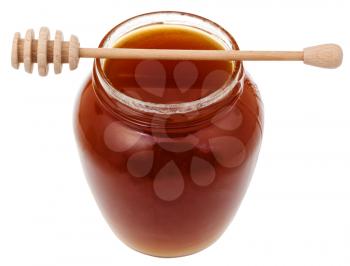 glass jar with brown honey and wooden stick isolated on white background