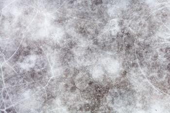 natural background - ice surface of frozen pond in cold winter day