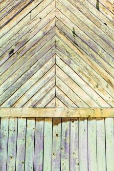 background from shabby green painted planks on wall of old wooden house