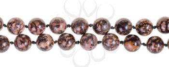 two strings of beads from rhodonite gem stone isolated on white background