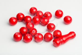 several red painted bone beads on white