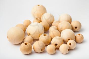 several natural wooden beads on white background