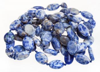 tangled necklace from blue lazurite gemstone beads on white background